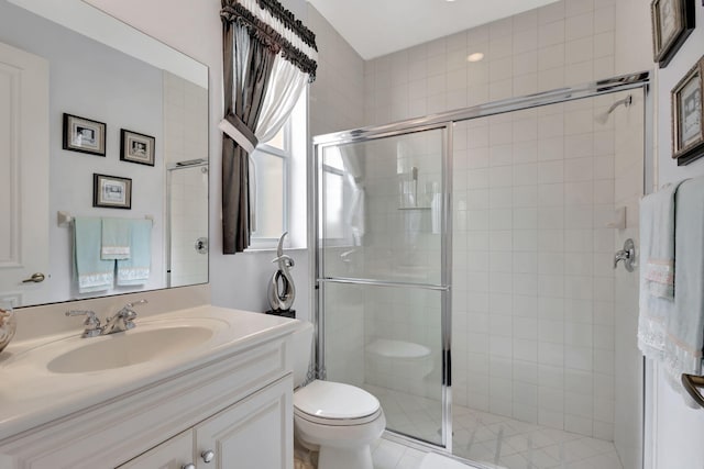 bathroom with toilet, an enclosed shower, and vanity