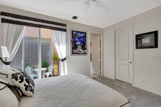 carpeted bedroom featuring access to outside, visible vents, and a ceiling fan