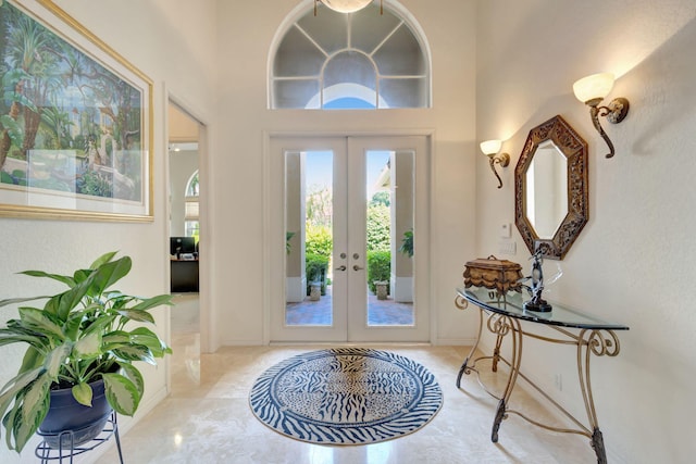 entryway with french doors and a towering ceiling