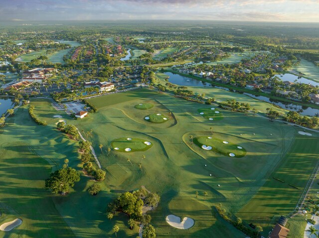 drone / aerial view featuring view of golf course and a water view