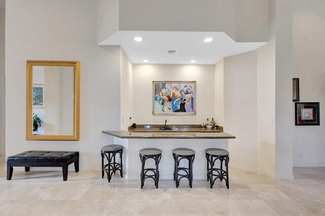 dining room with a tray ceiling, ceiling fan, and a towering ceiling