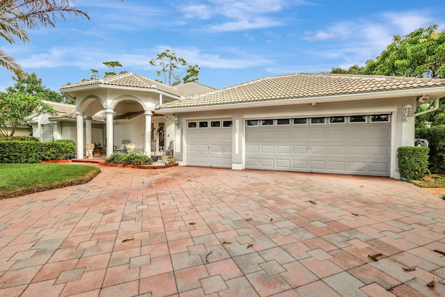 mediterranean / spanish-style home with a garage