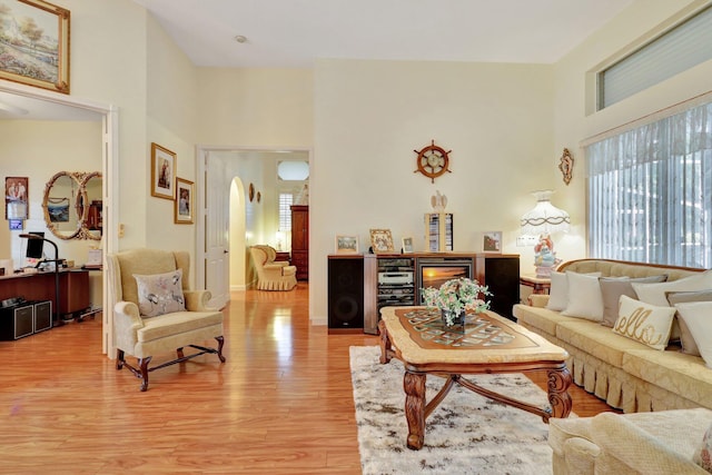 living room featuring a high ceiling and hardwood / wood-style flooring