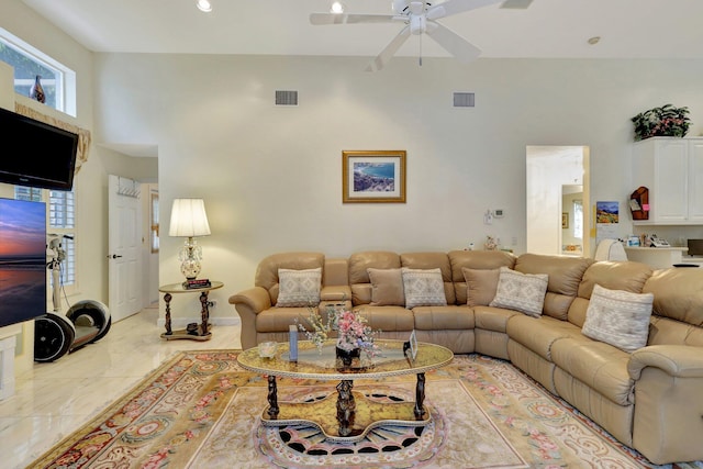 living room featuring a high ceiling and ceiling fan