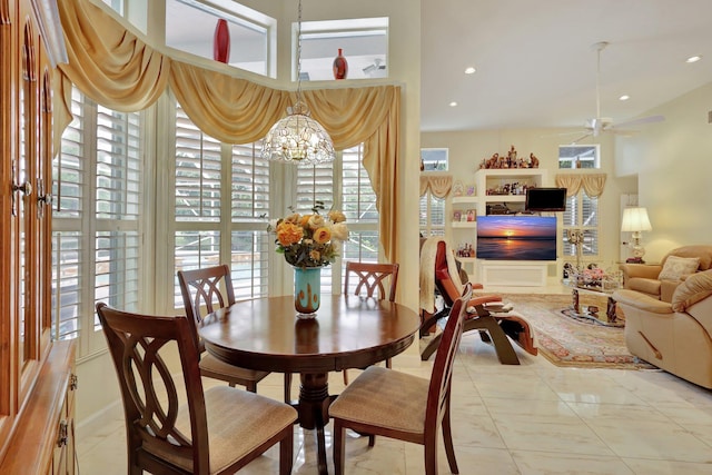 dining space with ceiling fan with notable chandelier