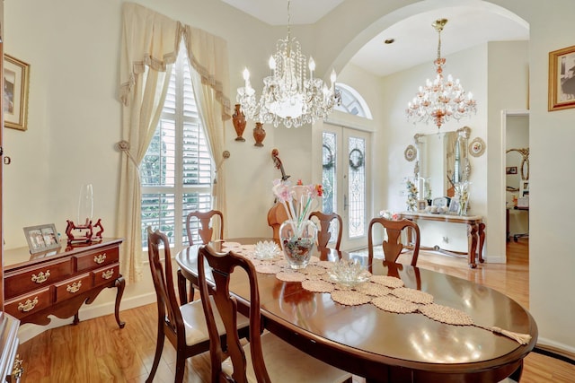 dining room with light wood-type flooring and french doors