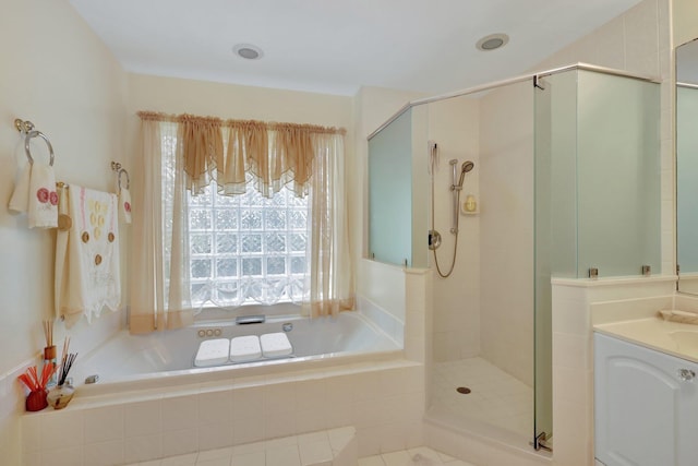 bathroom with shower with separate bathtub and vanity