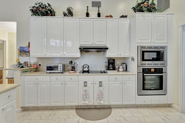 kitchen featuring white cabinets, black electric stovetop, and stainless steel oven