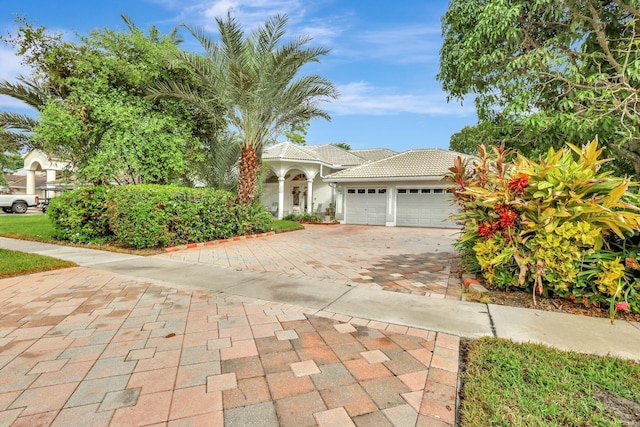 mediterranean / spanish-style house with a garage