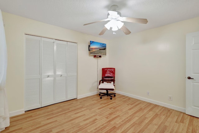 unfurnished room featuring ceiling fan, a textured ceiling, and light wood-type flooring