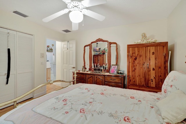 bedroom featuring ceiling fan, hardwood / wood-style flooring, and a closet