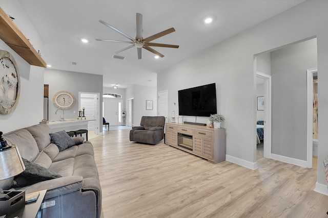 living room featuring ceiling fan and light wood-type flooring