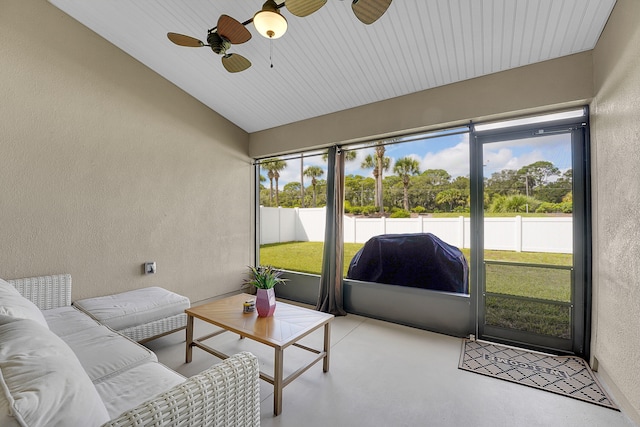 sunroom / solarium featuring ceiling fan and vaulted ceiling