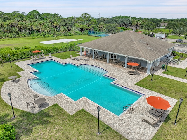 view of pool featuring a yard and a patio area