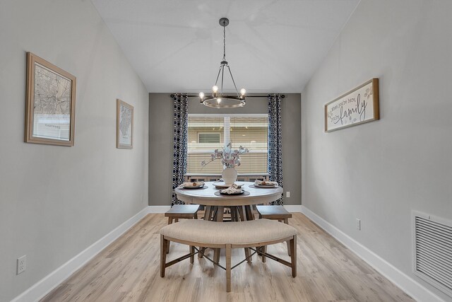 dining space with a chandelier and light wood-type flooring