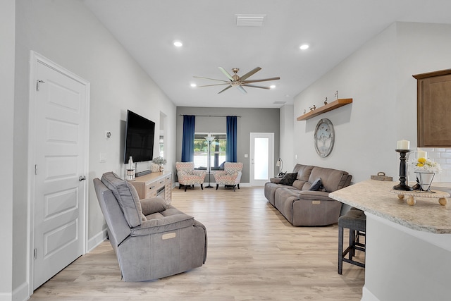 living room with ceiling fan and light hardwood / wood-style floors