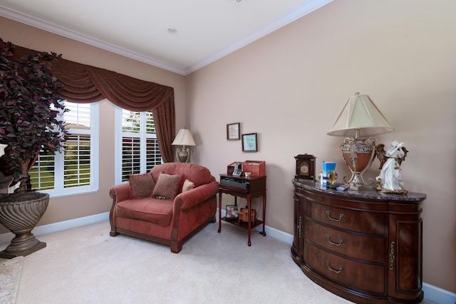 sitting room with ornamental molding and light carpet