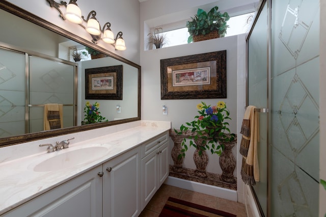 bathroom featuring vanity, tile patterned flooring, and a shower with door