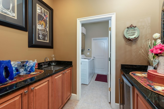 bathroom with sink, tile patterned floors, and washing machine and clothes dryer