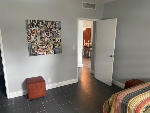 bedroom featuring dark tile patterned flooring