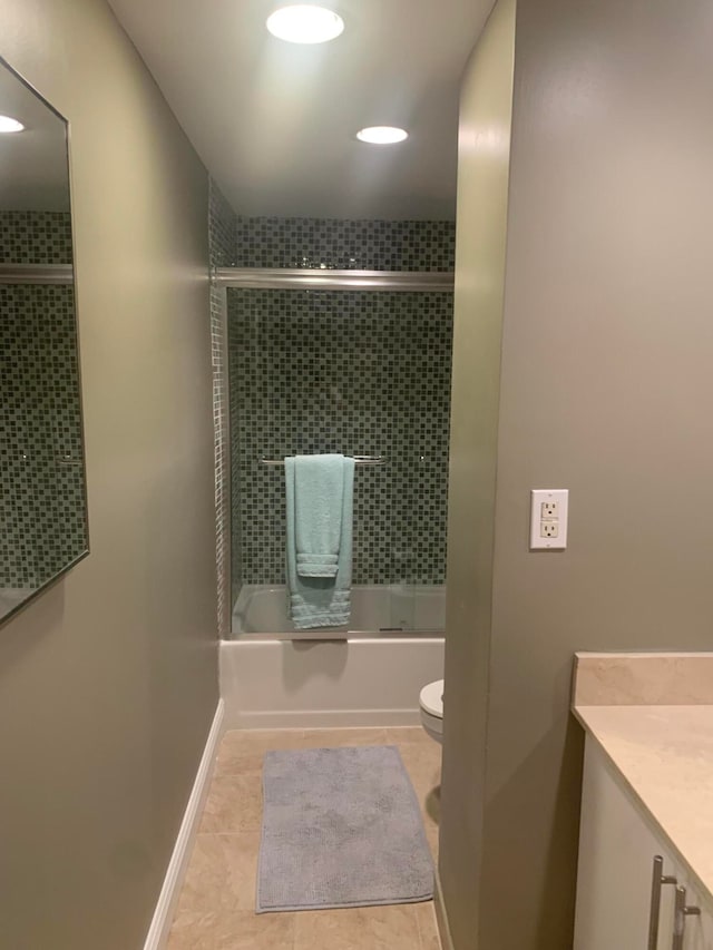 full bathroom featuring enclosed tub / shower combo, vanity, toilet, and tile patterned floors