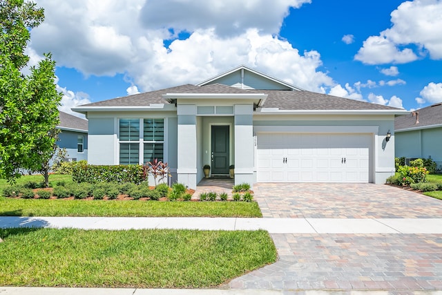 view of front of house with a garage and a front yard