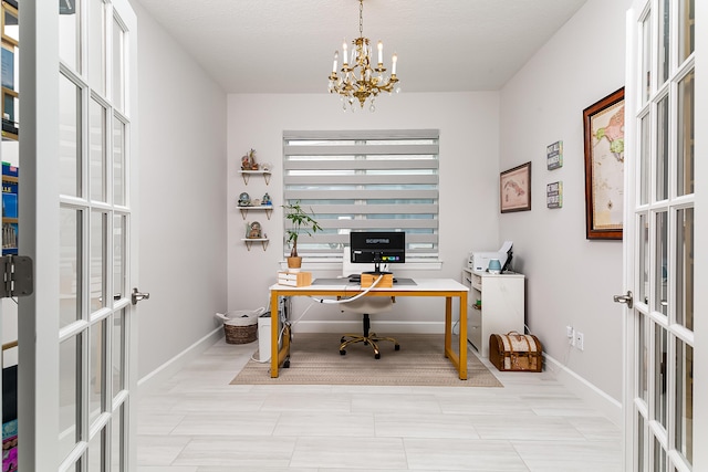 office space with french doors, an inviting chandelier, and a textured ceiling