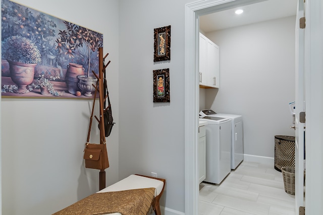 laundry room featuring cabinets and washing machine and dryer