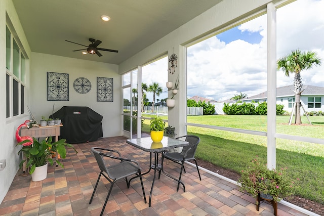 sunroom / solarium featuring ceiling fan