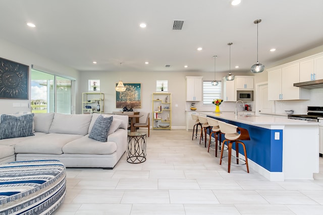 living room with sink and light tile patterned floors