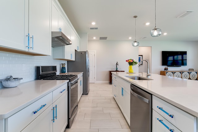 kitchen with pendant lighting, sink, white cabinetry, appliances with stainless steel finishes, and exhaust hood