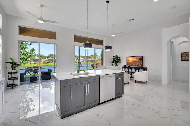 kitchen featuring sink, a water view, decorative light fixtures, gray cabinetry, and dishwasher