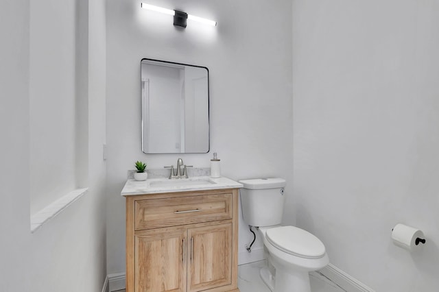 bathroom with toilet and vanity