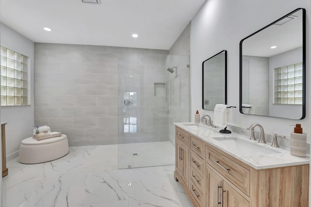 bathroom featuring tiled shower and vanity