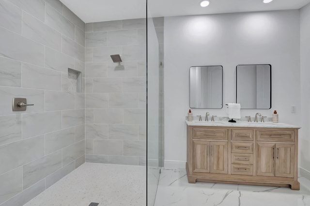 bathroom with vanity and tiled shower