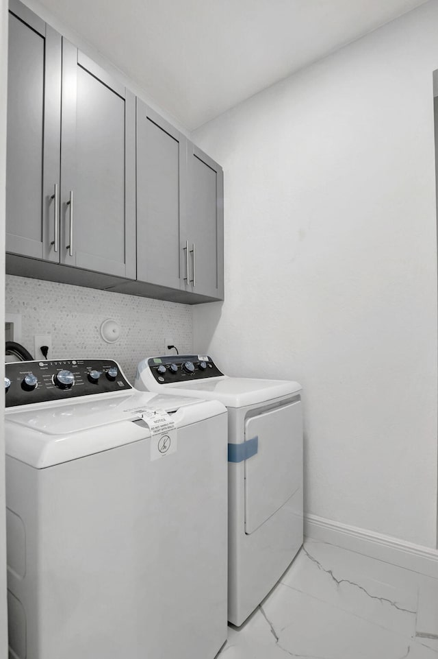 laundry area featuring cabinets and separate washer and dryer