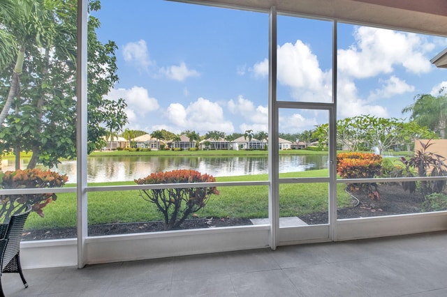 unfurnished sunroom with a water view