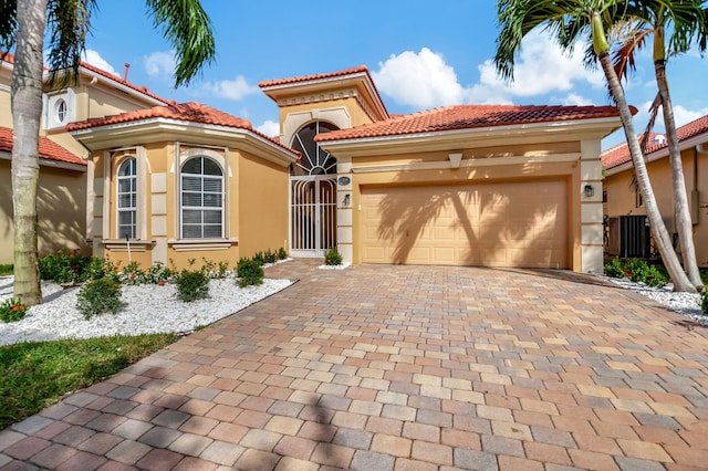 mediterranean / spanish-style house with a garage