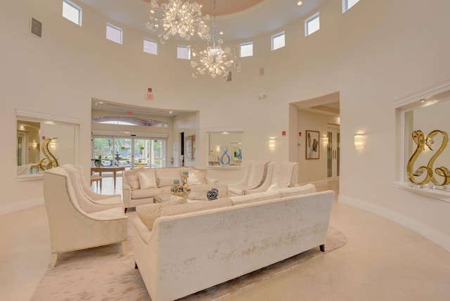 living room with a towering ceiling and a chandelier