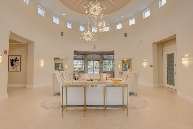 living room featuring a high ceiling and a chandelier