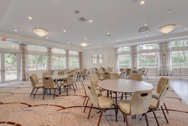 dining space with plenty of natural light and ornamental molding