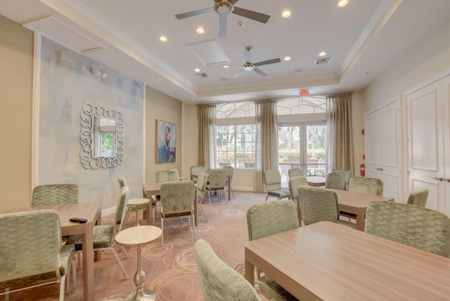 interior space with a tray ceiling, ceiling fan, and crown molding