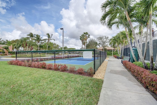 view of sport court featuring a lawn