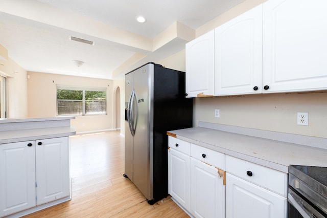 kitchen with stainless steel refrigerator with ice dispenser, light hardwood / wood-style flooring, and white cabinetry