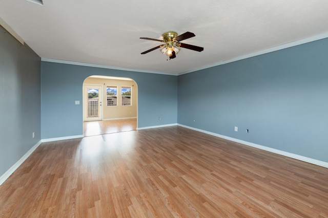 spare room with ornamental molding, light wood-type flooring, and ceiling fan