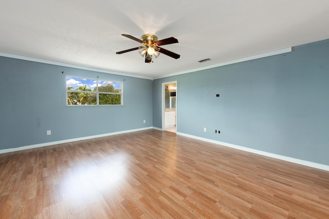 spare room with crown molding, light wood-type flooring, and ceiling fan