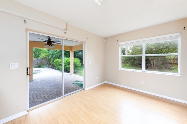 unfurnished room with light wood-type flooring and ceiling fan