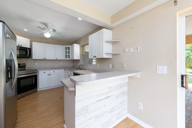 kitchen featuring kitchen peninsula, white cabinets, ceiling fan, appliances with stainless steel finishes, and light hardwood / wood-style flooring