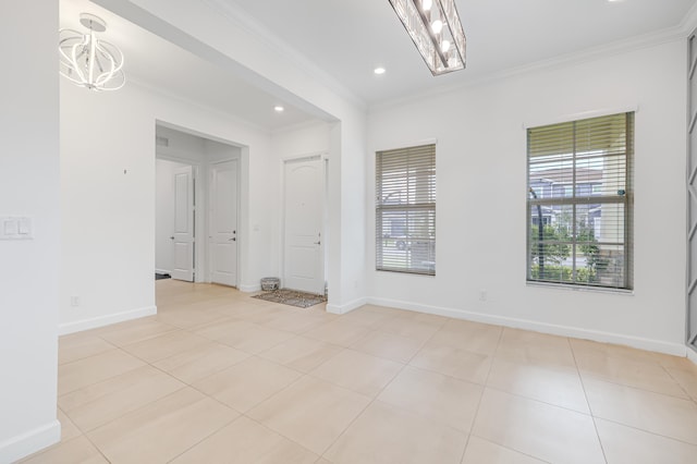 unfurnished room with a notable chandelier, plenty of natural light, light tile patterned flooring, and crown molding