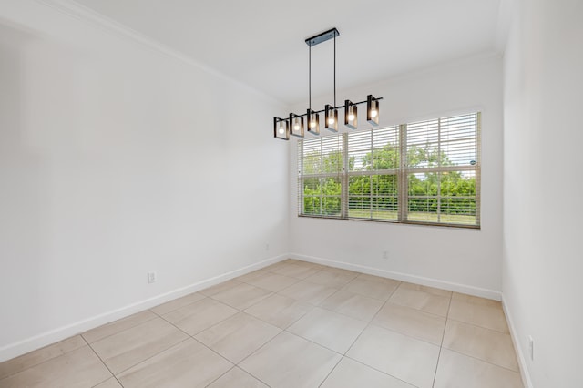 tiled empty room with ornamental molding and an inviting chandelier